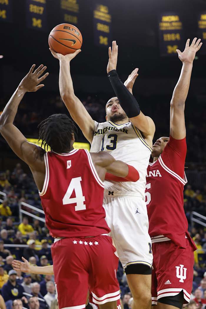 Michigan Wolverines forward Olivier Nkamhoua (13) shoots against Indiana Hoosiers forward Anthony Walker (4).  